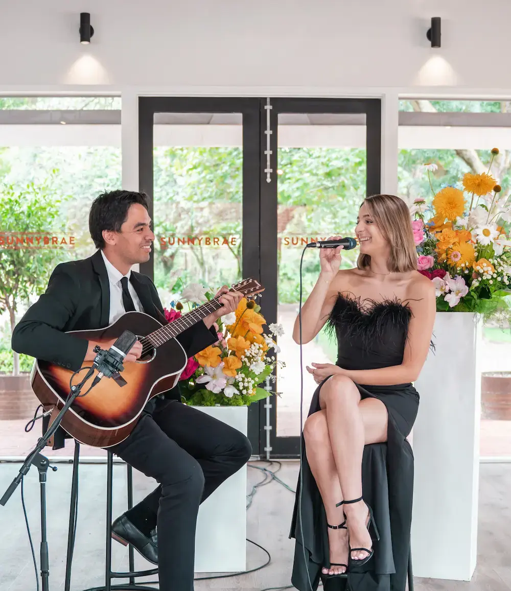 Two singers that work for AML singing at Sunnybrae.