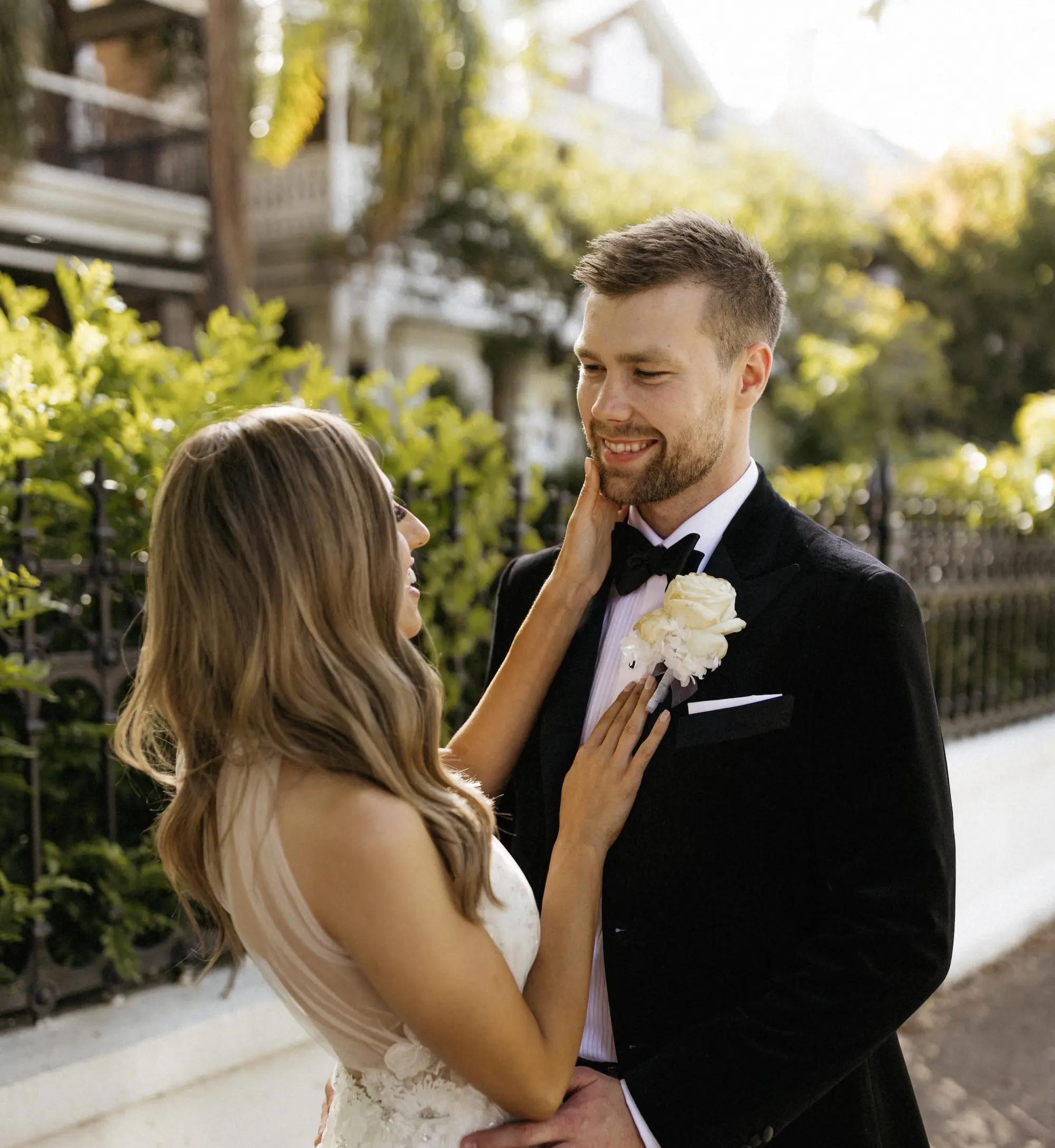 Emilia putting her hands on her partner Lachlan's face.
